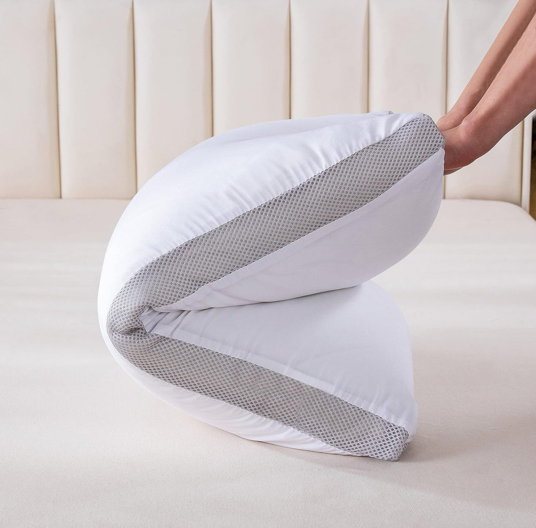 Triangular pillow with white and gray mesh on a bed