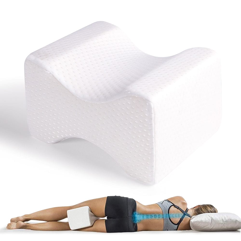 Woman lying on a white mattress with a wedge-shaped foam roller above her back.
